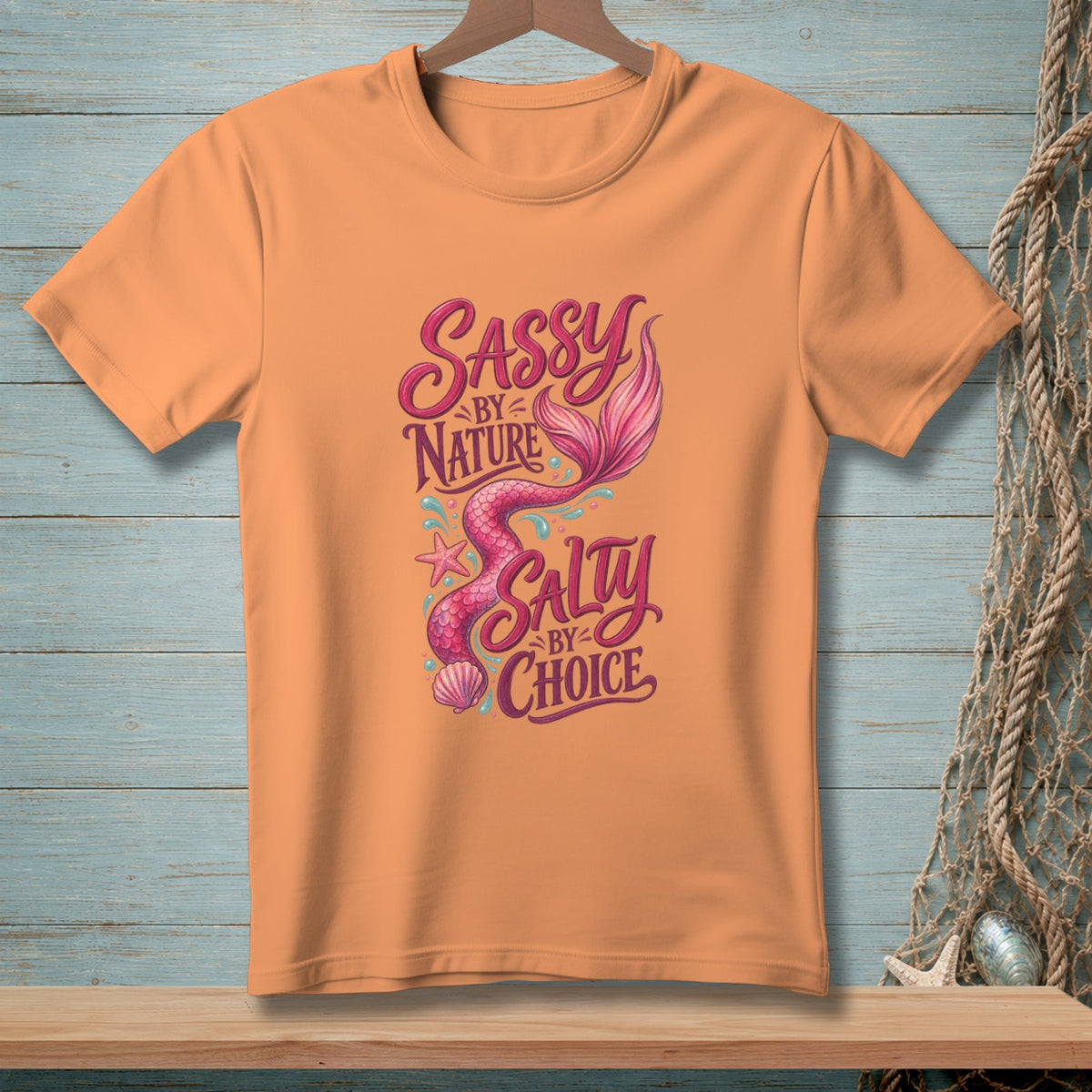 Orange t-shirt with a mermaid graphic and text "Sassy by Nature, Salty by Choice".