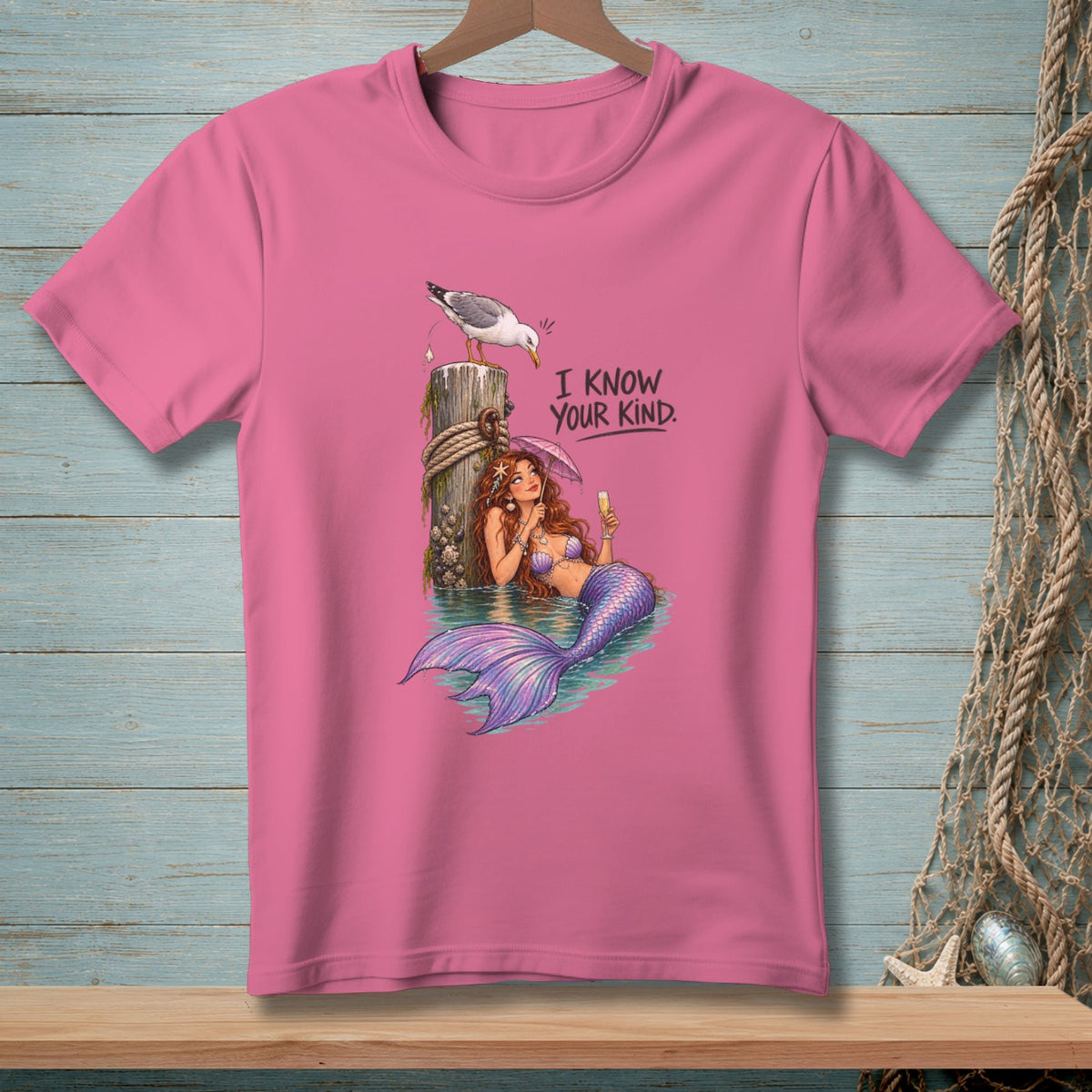 Pink t-shirt with a mermaid, seagull, and text that reads "I know your kind."