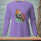 Mermaid with lobster and seashell on rocks, on a lavender long-sleeve shirt.