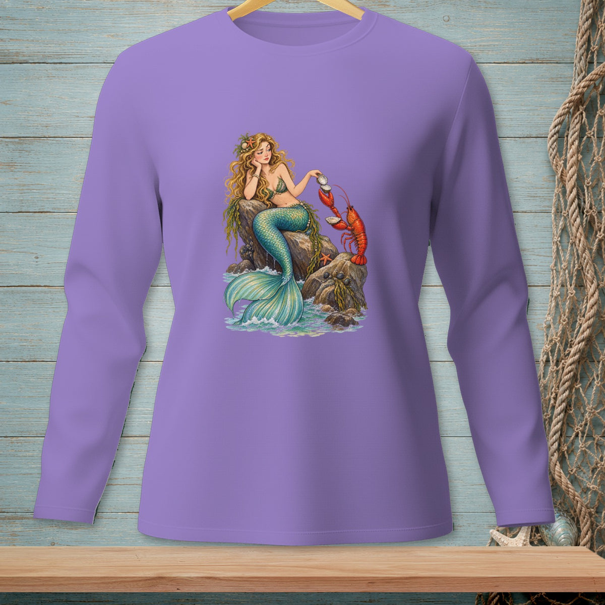 Mermaid with lobster and seashell on rocks, on a lavender long-sleeve shirt.