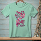 Mint green t-shirt with mermaid graphic and text "Sassy by Nature Salty by Choice".