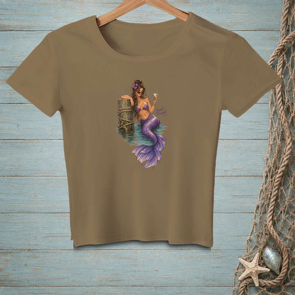 Brown crewneck t-shirt featuring an illustration of a mermaid holding a drink while leaning against a wooden piling.