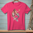 Pink t-shirt with a mermaid holding a pufferfish and leaning on a buoy that reads "GOOD VIBES ONLY".