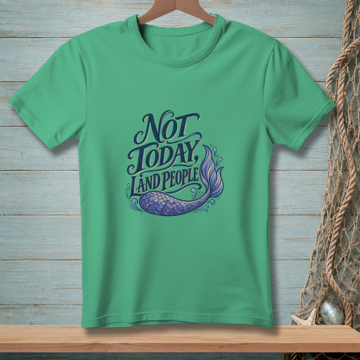 Green t-shirt with "Not Today, Land People" text and a mermaid tail graphic.
