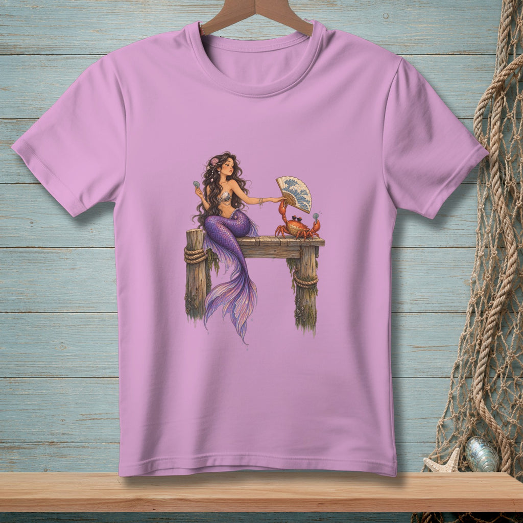 Mermaid on pier holding fan with a crab, purple t-shirt graphic.