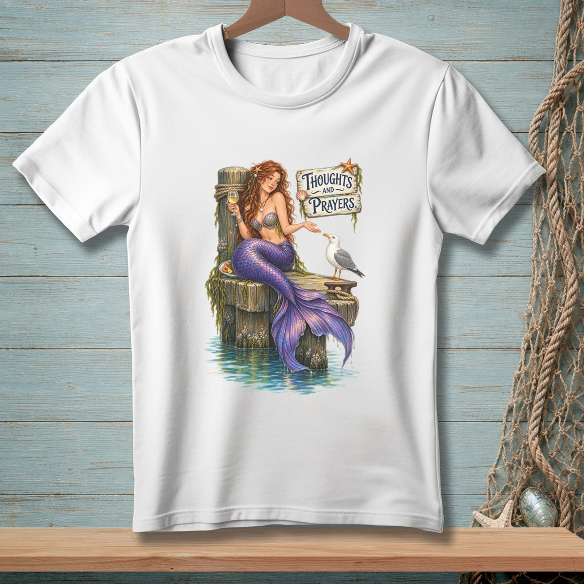 Mermaid on a dock with wine, seagull, and sign saying "Thoughts and Prayers."