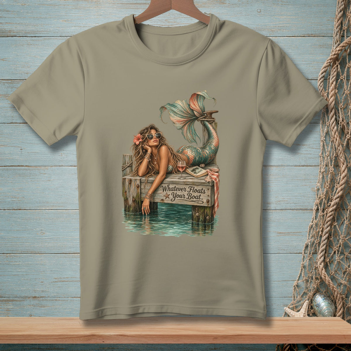 Mermaid lounging on a dock with text "Whatever Floats Your Boat".