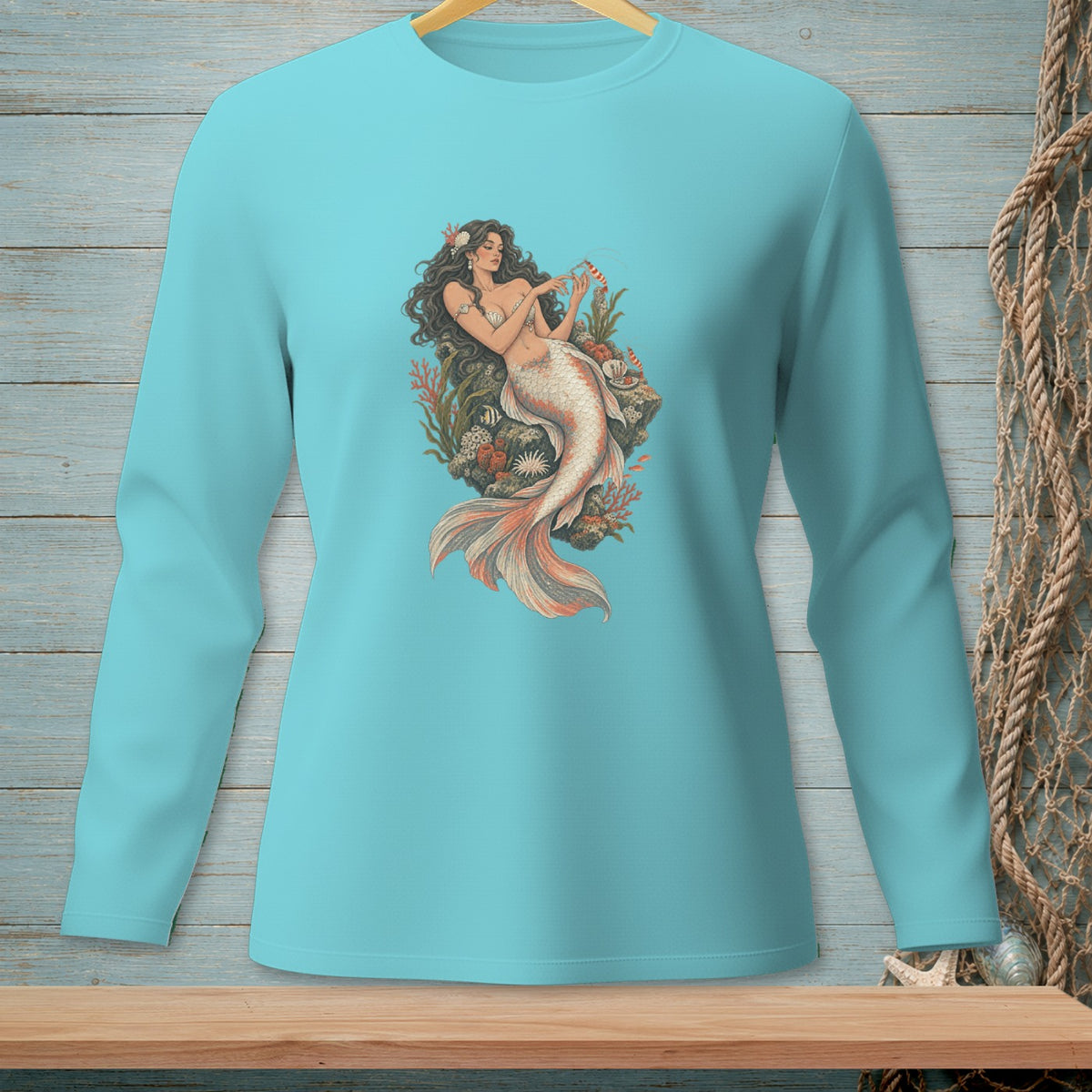 Long sleeve teal t-shirt with a detailed mermaid graphic and coral elements.