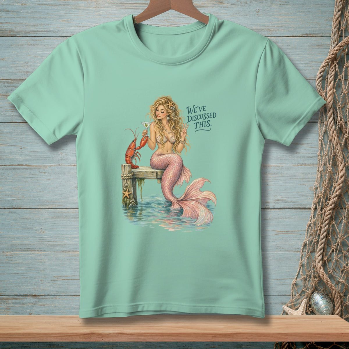 Mermaid with lobster and cocktail, text reads "We've discussed this."