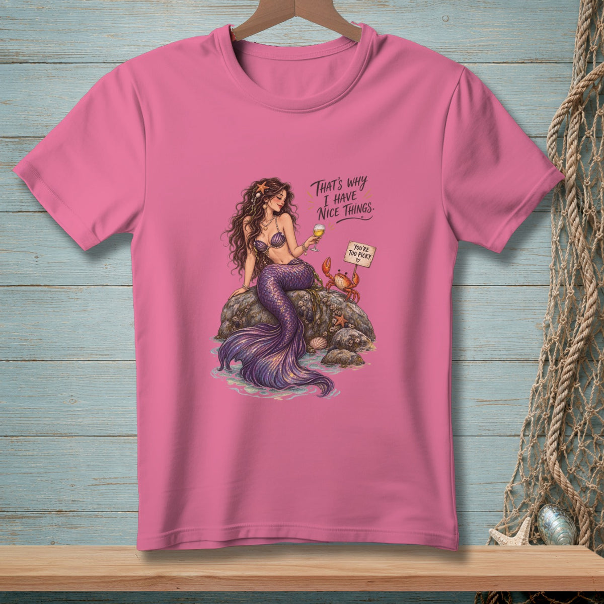 Pink t-shirt with illustration of a mermaid, crab, and text "That's why I have nice things."