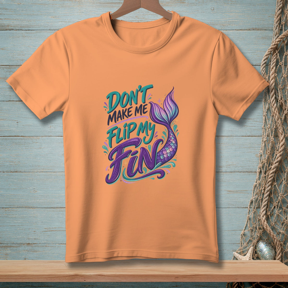 Orange t-shirt with text "Don't Make Me Flip My Fin" and mermaid tail.