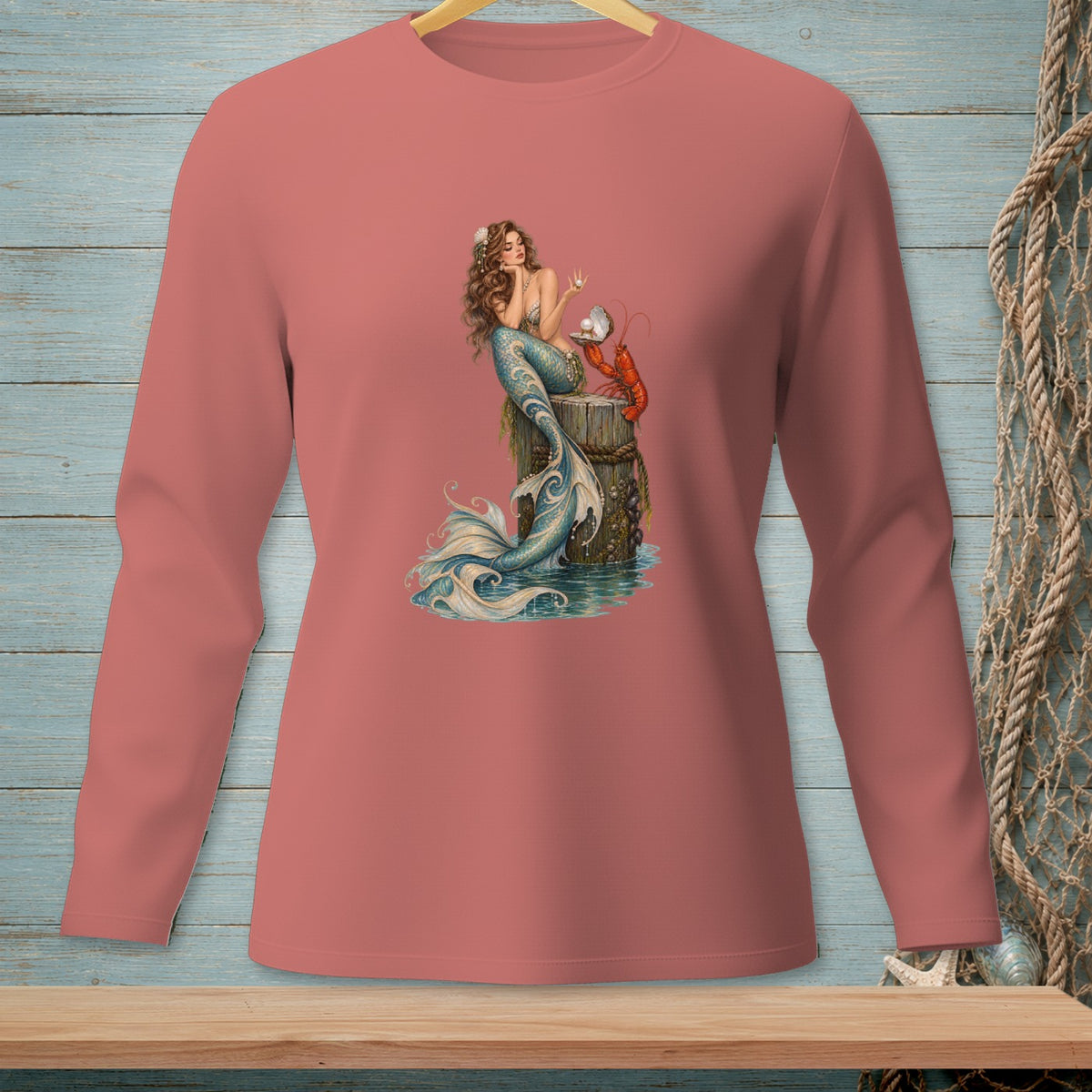 Mermaid with lobster and pearl on wooden post design on a coral long-sleeved shirt.
