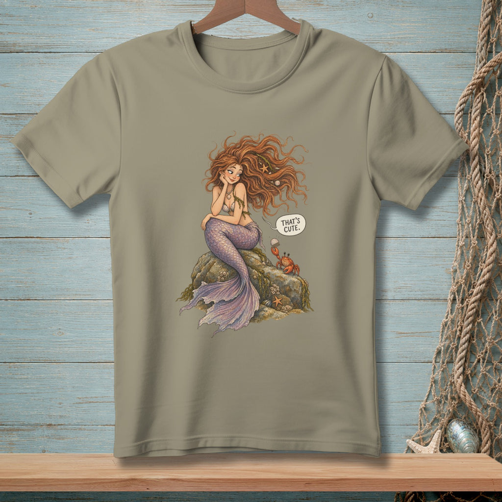 Illustration of a mermaid with long red hair on a rock, with a crab and text bubble saying "That's cute."