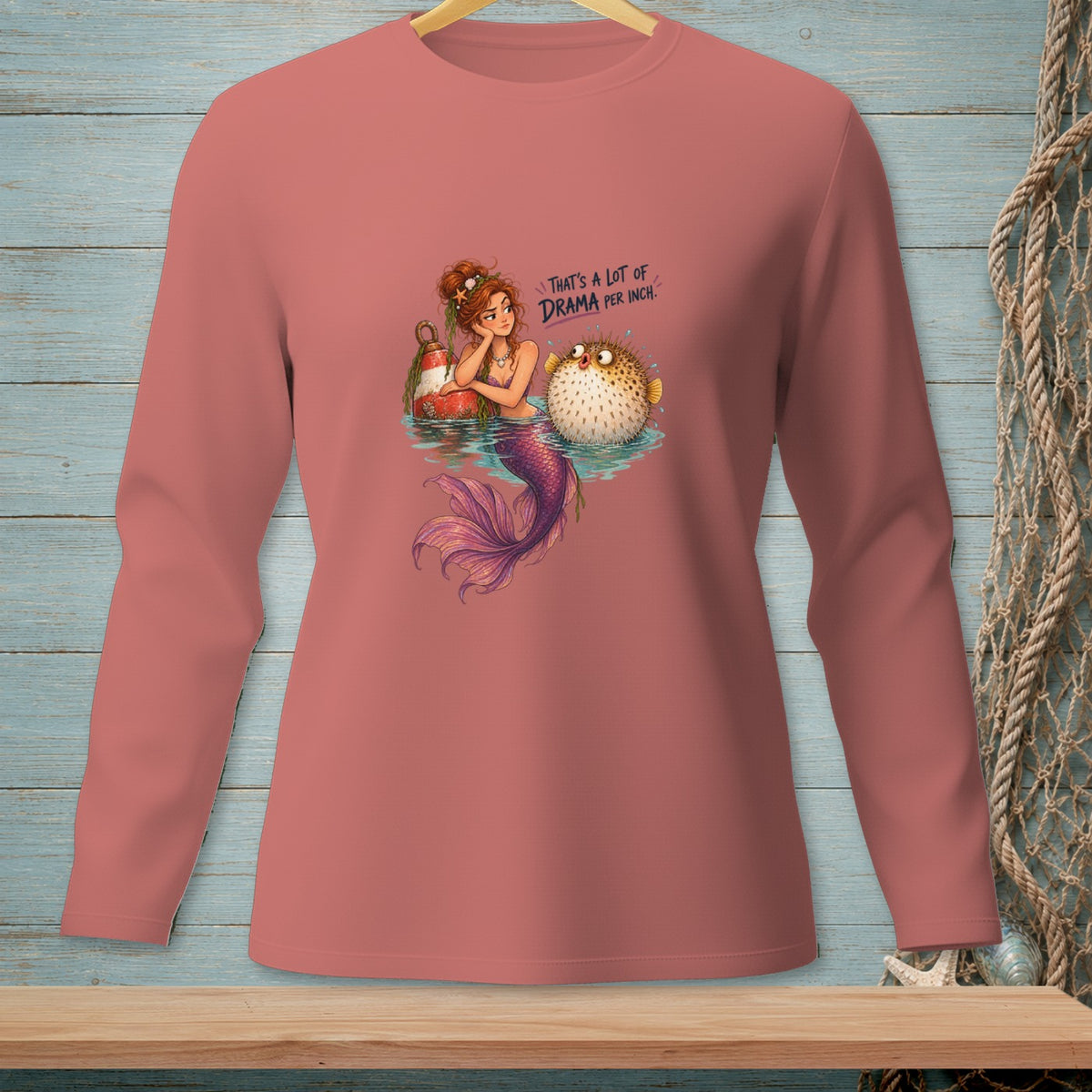 Mermaid and pufferfish with text "That's a lot of drama per inch."