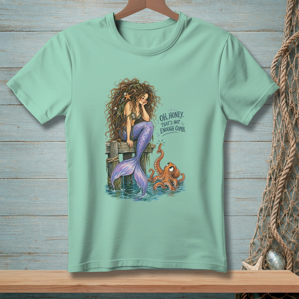 Mermaid with octopus sits on dock with text "Oh, honey. That's not enough comb."