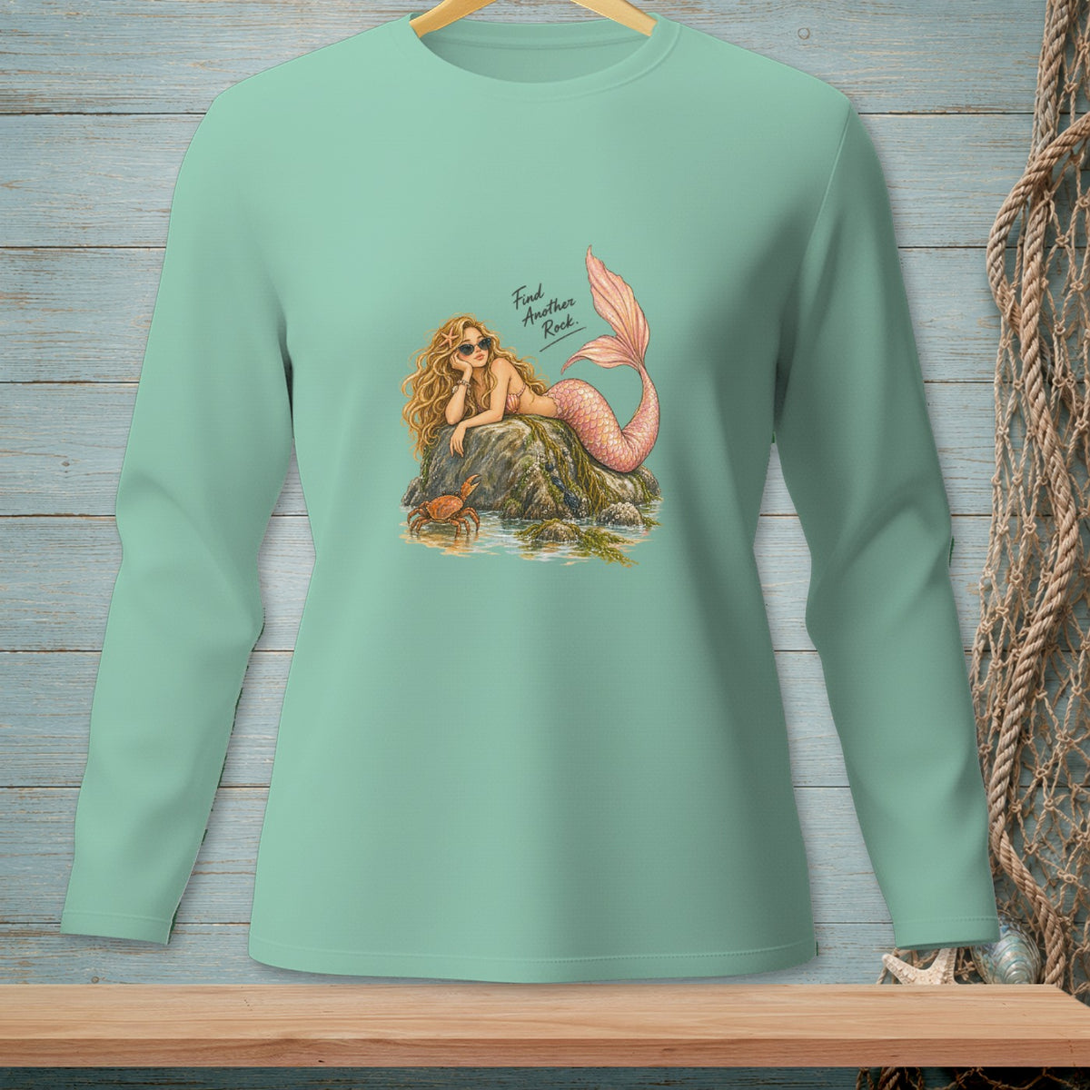Mint long-sleeve shirt with mermaid, crab, and text "Find Another Rock."