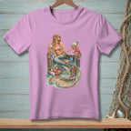 Mermaid holding coffee cup and book, crab with letters, on pier with fruit basket.