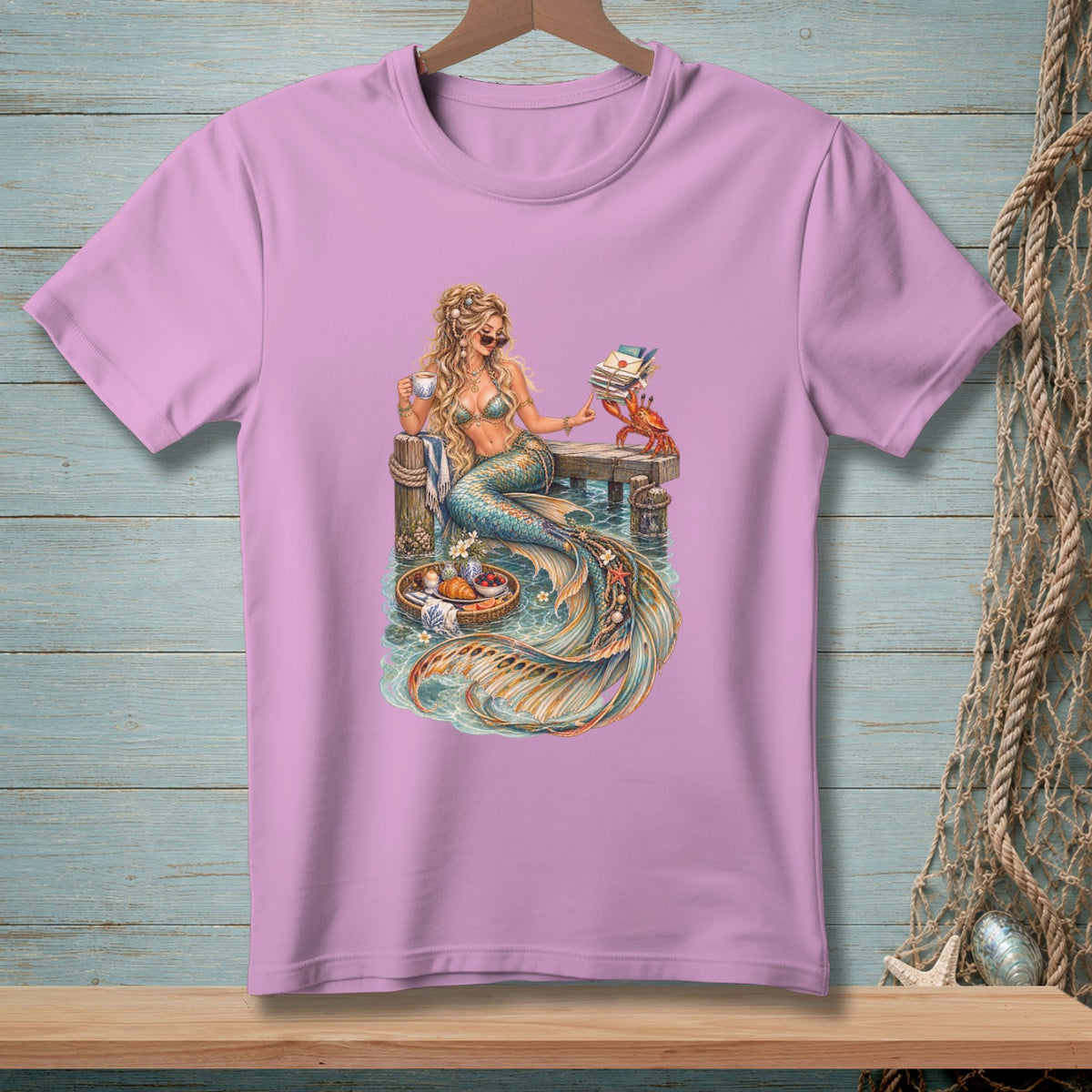 Mermaid holding coffee cup and book, crab with letters, on pier with fruit basket.