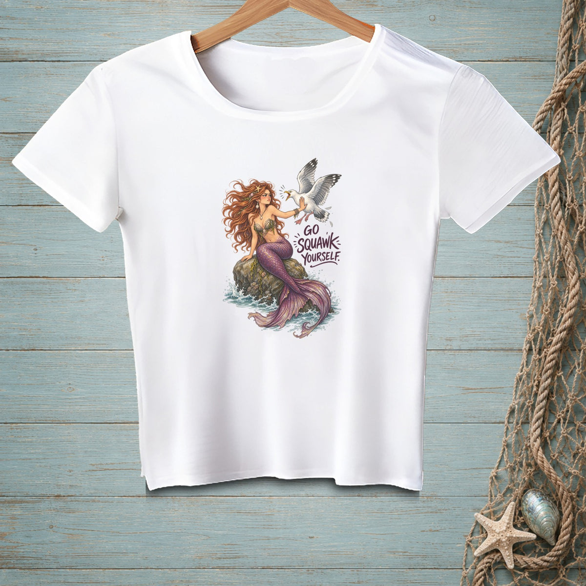 White t-shirt with illustration of a mermaid and a seagull with text "GO SQUAWK YOURSELF".