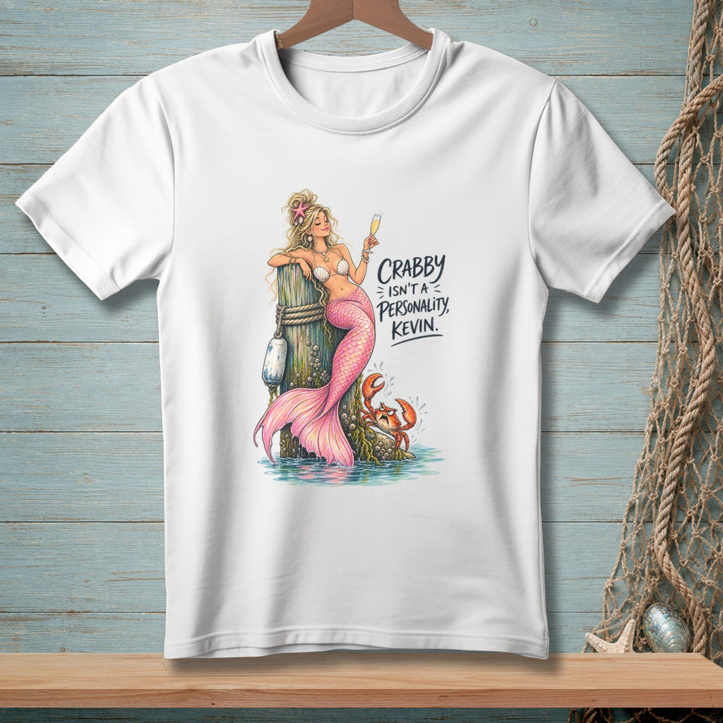 White t-shirt with a drawing of a mermaid and crab, text reads "Crabby isn't a personality, Kevin."