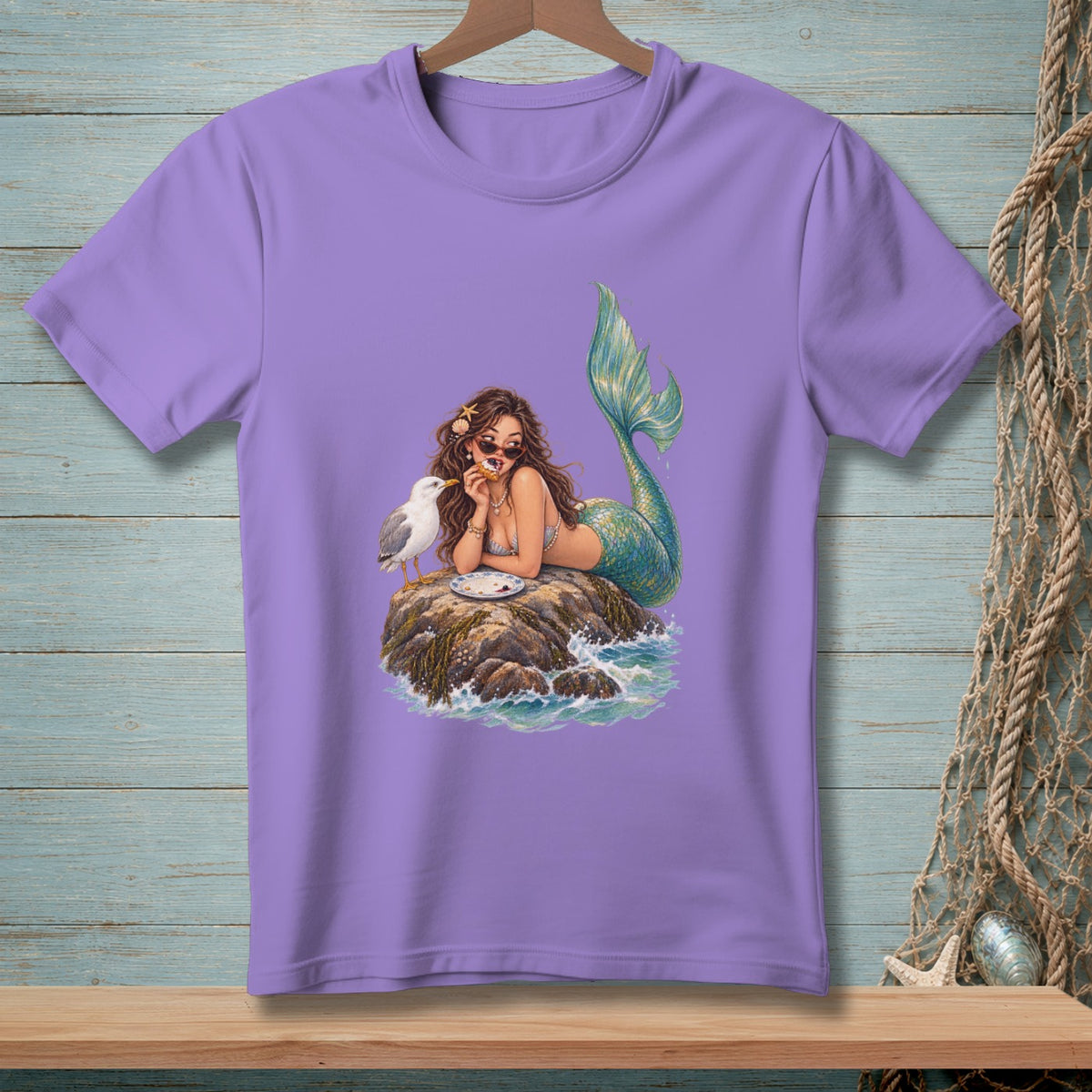 Mermaid on rock with seagull eating, on purple t-shirt.