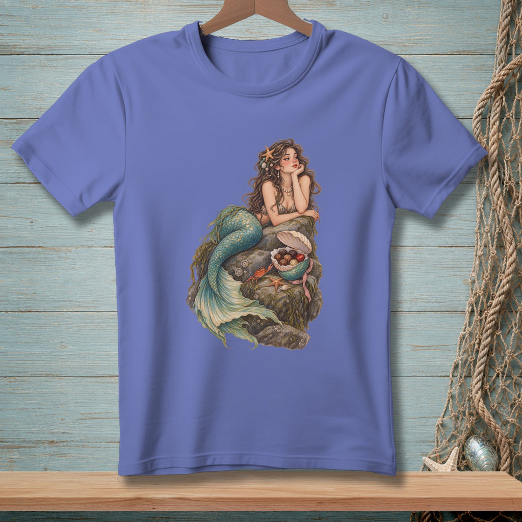Mermaid with treasure chest on rock, featured on a purple t-shirt.