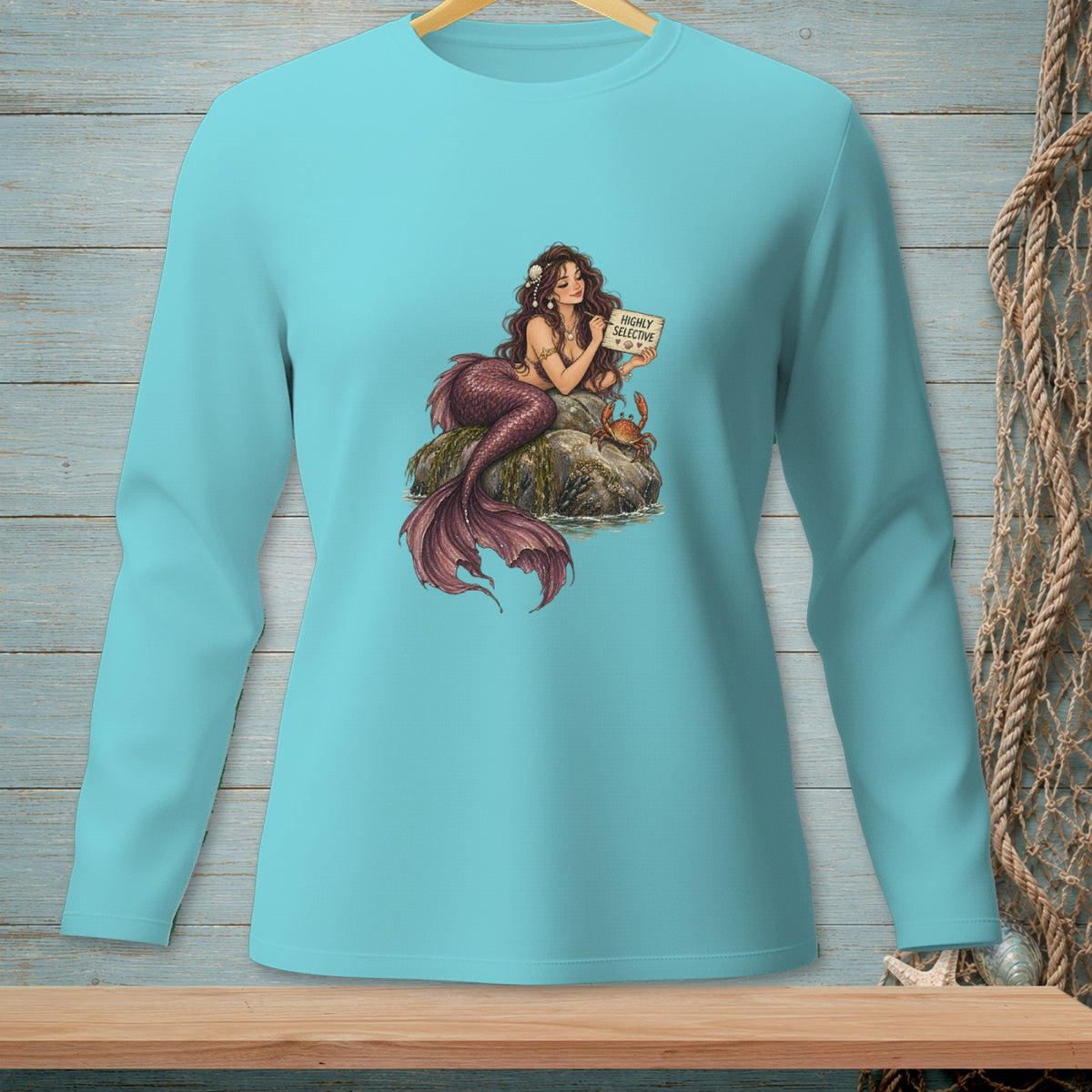 Mermaid holding sign "Highly Selective" with crab and seashells.