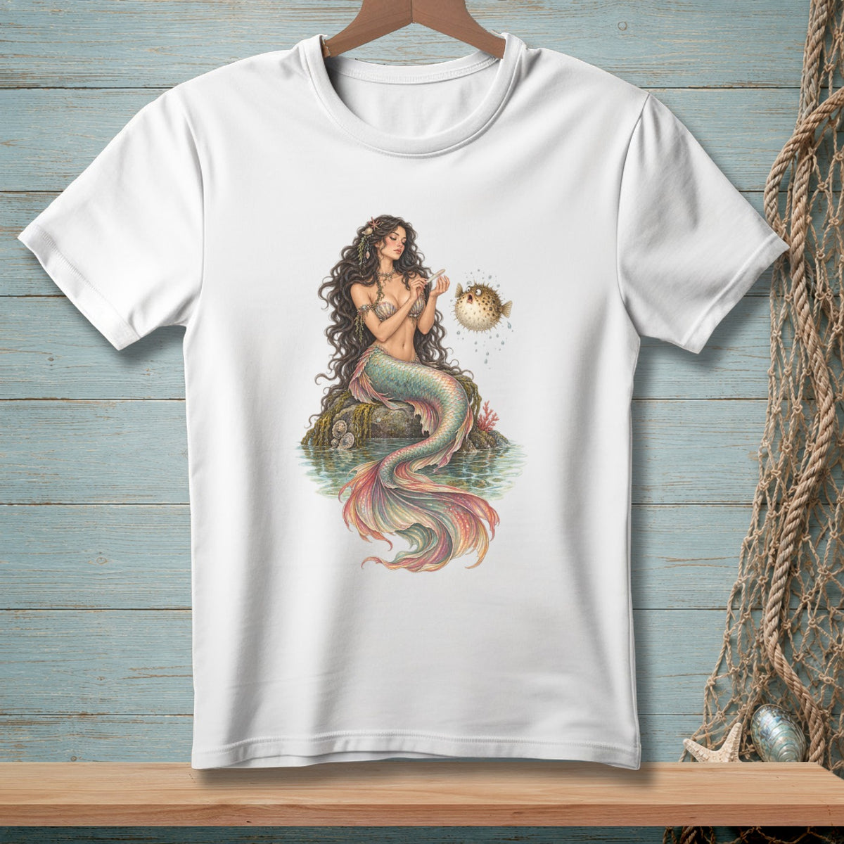 White t-shirt with a detailed illustration of a mermaid interacting with a pufferfish.