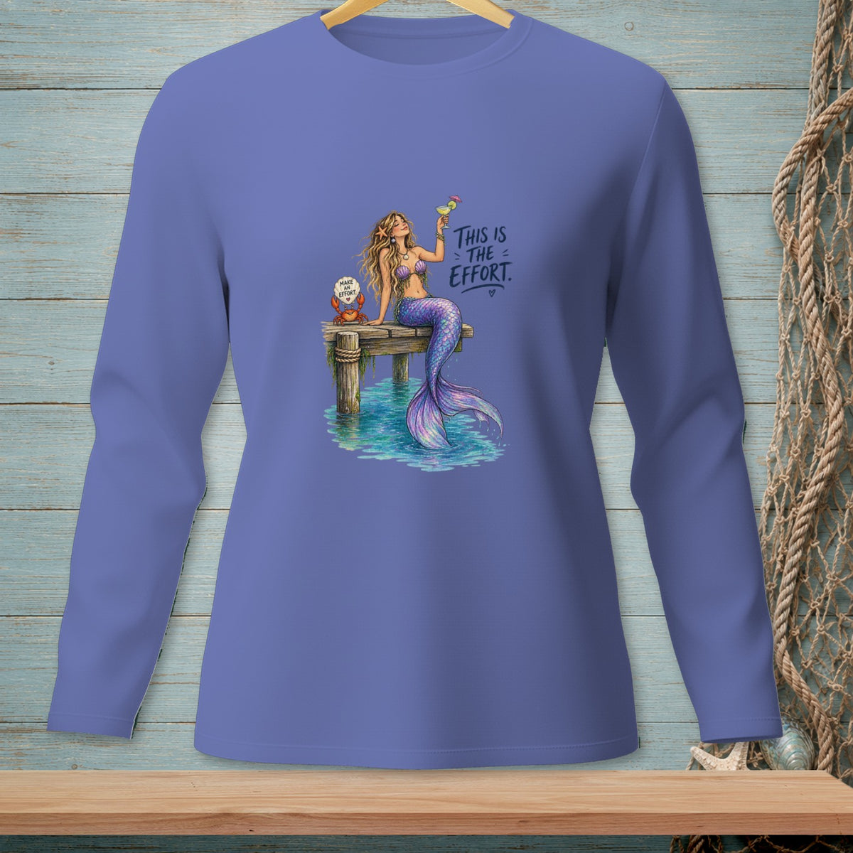 Mermaid with drink on dock, reads "This is the effort".