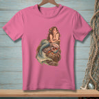 Pink t-shirt with illustration of a mermaid on a rock with a seashell.