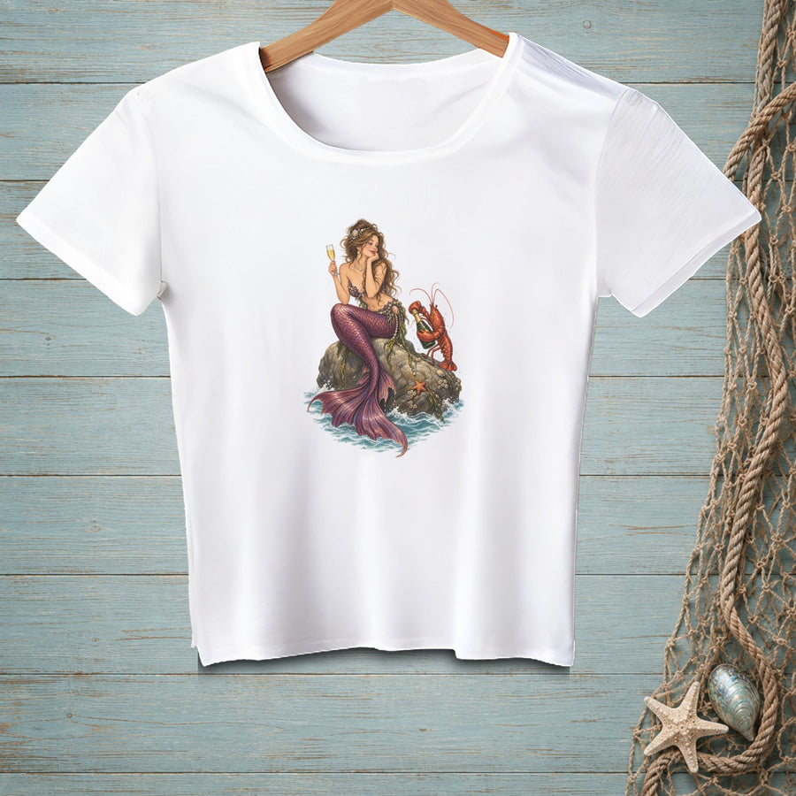 Mermaid with lobster and champagne glass sitting on a rock.