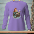 Mermaid holding wine, feeding a bird on a rock with ocean waves.
