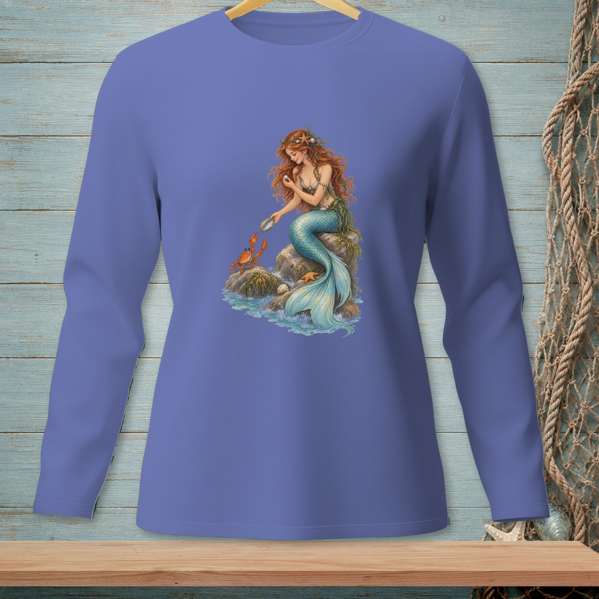 Long-sleeved shirt with a graphic of a mermaid and crab on a rock in the sea.