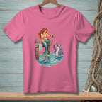 Pink t-shirt with mermaid pouring champagne for a dolphin on a wooden pier.