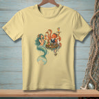 Light yellow t-shirt with mermaid and octopus serving drinks in a tropical setting.