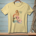 Yellow t-shirt with a mermaid, lobster, and text "WE'VE DISCUSSED THIS."