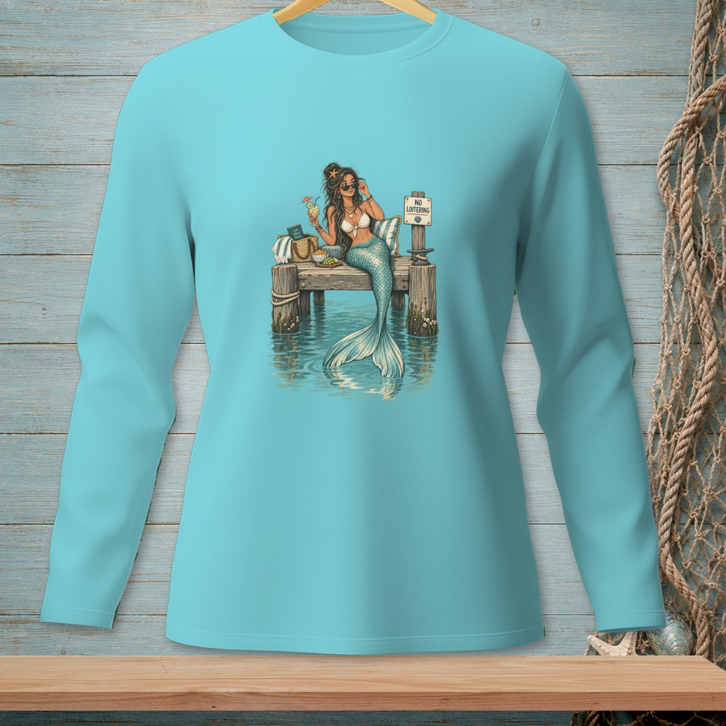 Mermaid with a drink sits on a dock next to a "No Loitering" sign.