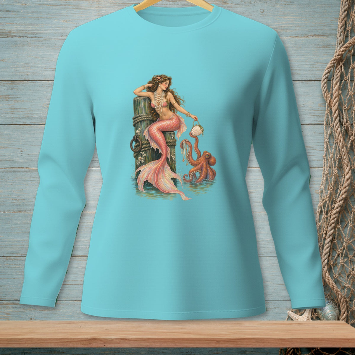 Mermaid with octopus and shell on pier art on a light blue long-sleeve shirt.