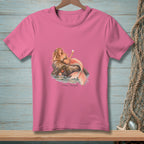 Pink t-shirt featuring an illustration of a mermaid lounging on a rock, holding a glass, with the text "Plans Changed."