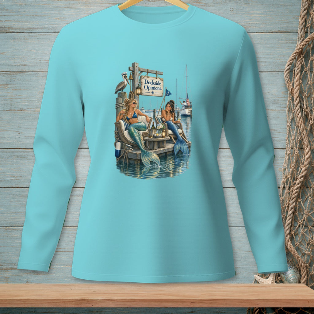 Two mermaids sit on a dock by the water, with a "Dockside Opinions" sign above them.