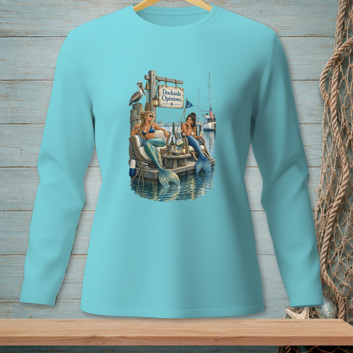 Two mermaids sit on a dock by the water, with a "Dockside Opinions" sign above them.